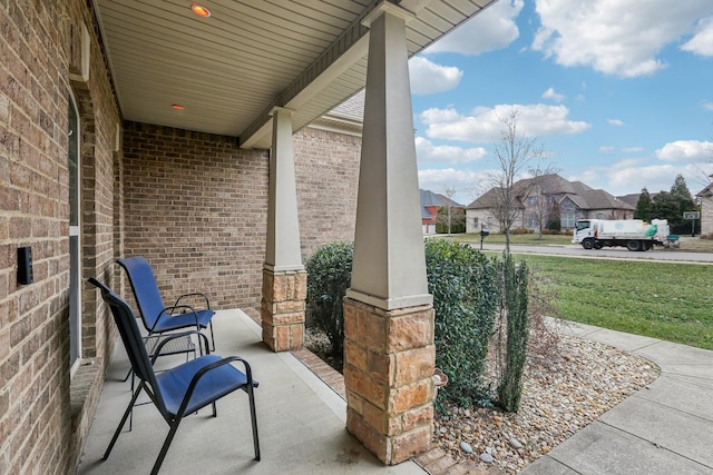 view of patio with a residential view and a porch