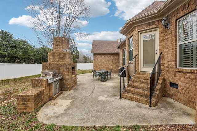 view of patio / terrace featuring area for grilling, entry steps, outdoor dining area, and fence