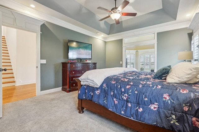 carpeted bedroom featuring crown molding, ceiling fan, baseboards, a tray ceiling, and recessed lighting