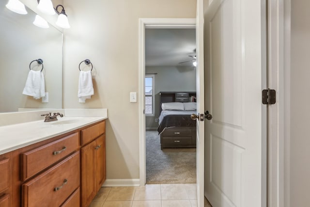 bathroom featuring tile patterned flooring, ceiling fan, vanity, and baseboards