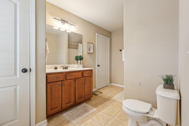 full bathroom with tile patterned floors, baseboards, toilet, and vanity