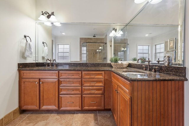 bathroom with a sink, a stall shower, and a wealth of natural light