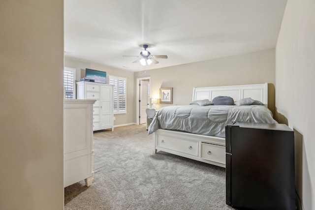 bedroom with baseboards, light carpet, and a ceiling fan