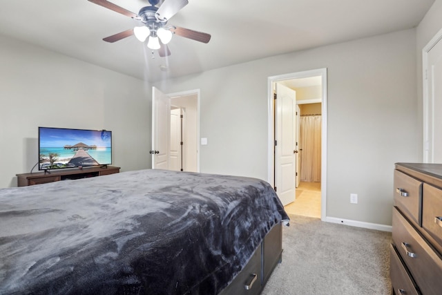 bedroom featuring light colored carpet, baseboards, and ceiling fan