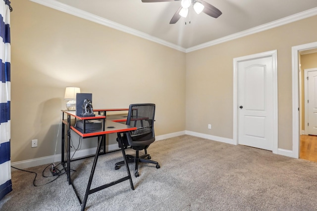 carpeted home office featuring baseboards, ornamental molding, and a ceiling fan