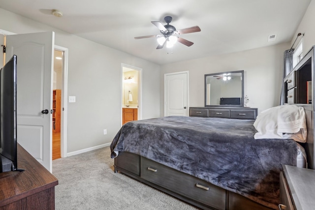 carpeted bedroom featuring visible vents, connected bathroom, a ceiling fan, and baseboards