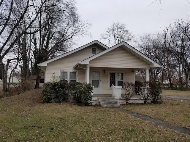 bungalow-style house with covered porch and a front yard