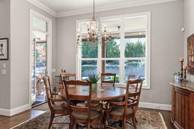 dining area with baseboards, ornamental molding, dark wood finished floors, and a chandelier