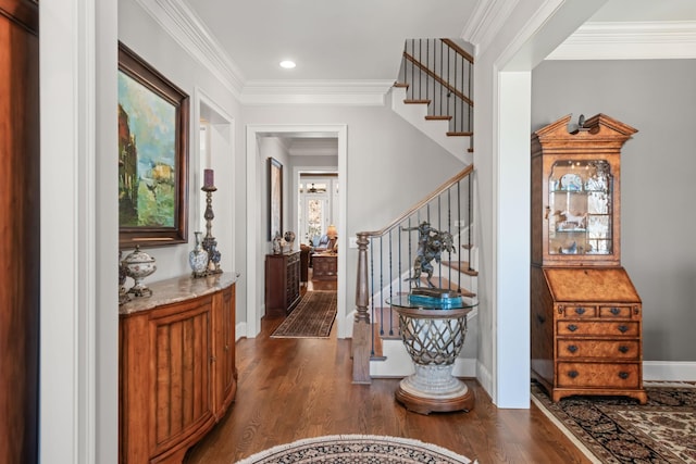 foyer entrance with stairway, dark wood-style flooring, and crown molding