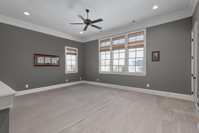 unfurnished room featuring baseboards, light carpet, visible vents, and crown molding