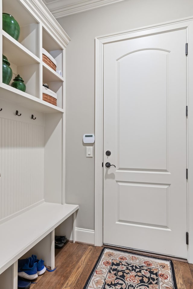 mudroom with baseboards, ornamental molding, and wood finished floors