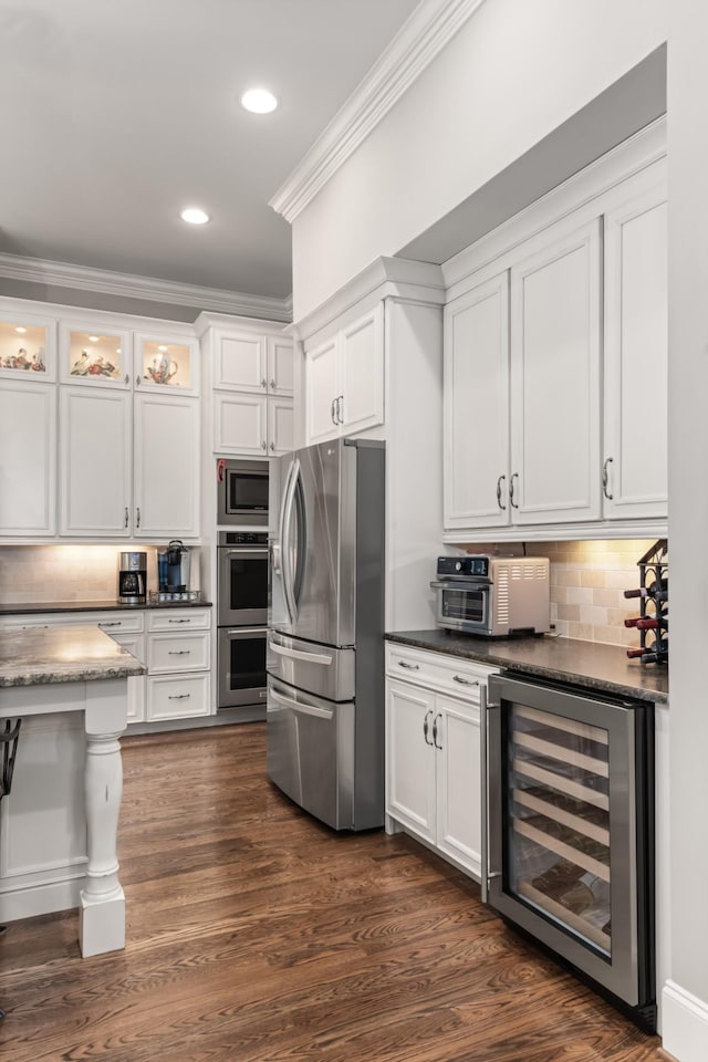 kitchen featuring stainless steel appliances, wine cooler, white cabinets, and ornamental molding