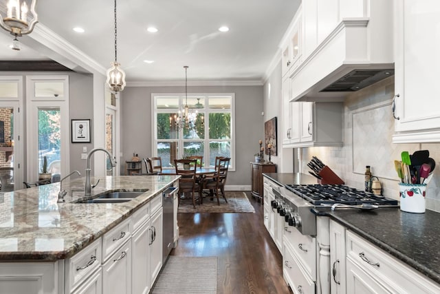 kitchen featuring premium range hood, dark wood-type flooring, a sink, appliances with stainless steel finishes, and crown molding