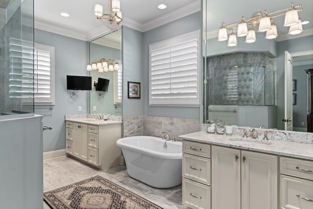 bathroom with marble finish floor, ornamental molding, a tile shower, and a sink