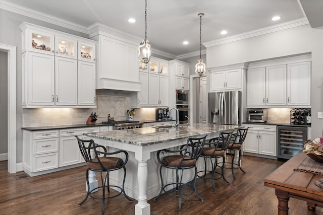 kitchen with dark wood-style floors, a breakfast bar area, stainless steel appliances, glass insert cabinets, and beverage cooler