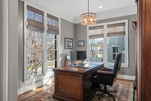 office space with light wood finished floors, plenty of natural light, and crown molding