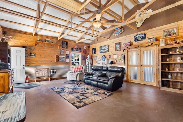 living area with high vaulted ceiling, wood walls, a ceiling fan, and finished concrete floors