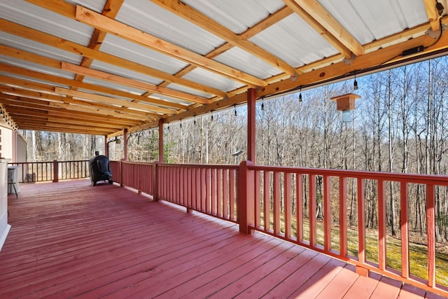 wooden deck featuring a view of trees