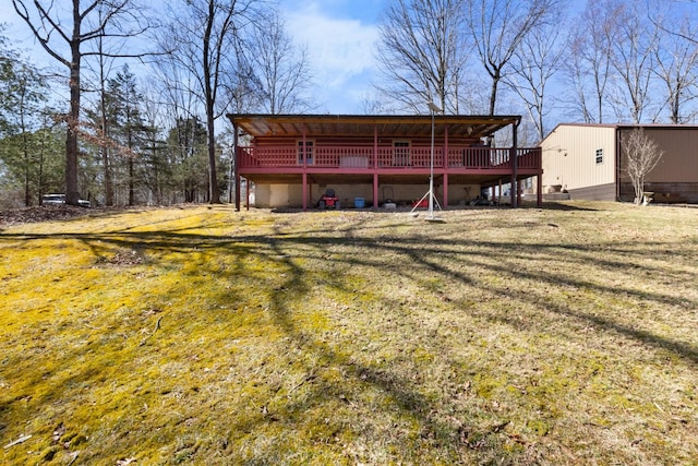 rear view of house featuring a deck and a yard