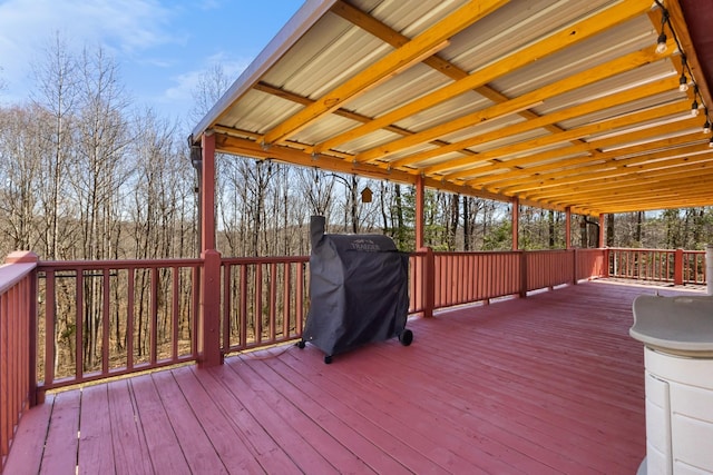 wooden terrace with a grill