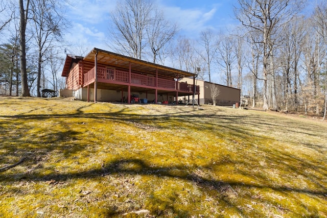 back of house with a lawn and a deck