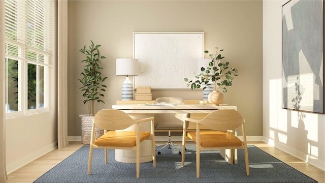 living area featuring baseboards and wood finished floors