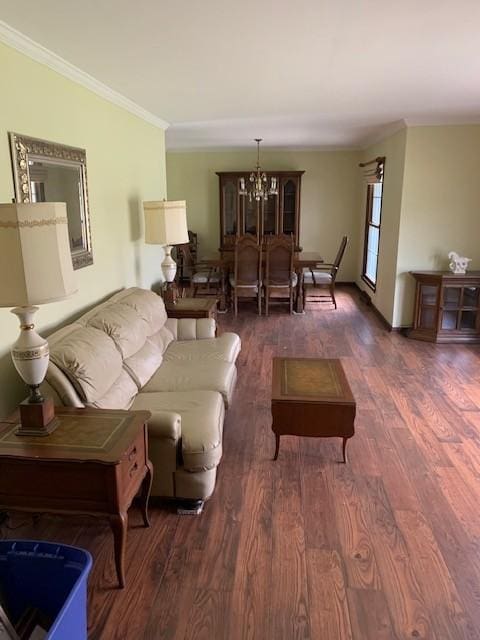 living area with a notable chandelier, ornamental molding, and wood finished floors