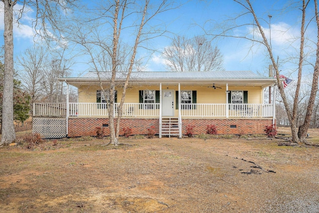 view of front facade with covered porch and metal roof