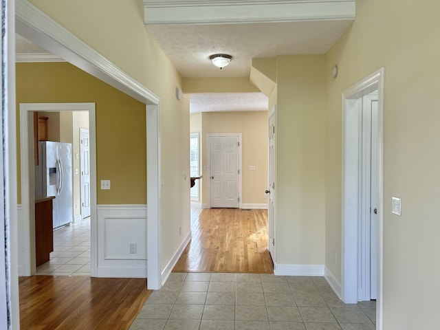 hall featuring a textured ceiling and tile patterned flooring