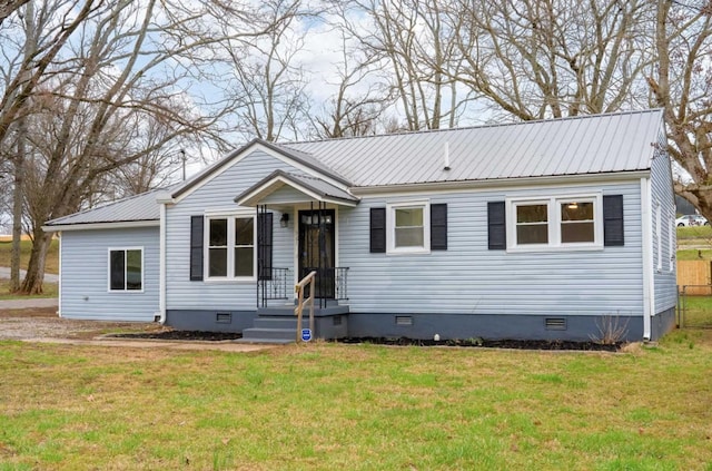 view of front facade featuring crawl space, metal roof, and a front lawn