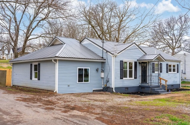 view of front of home with crawl space and metal roof