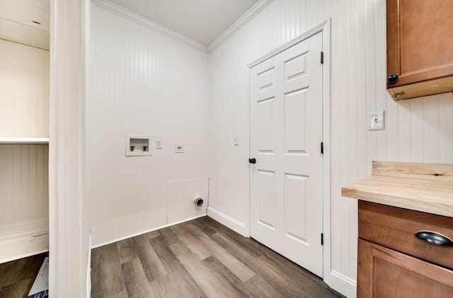 clothes washing area with dark wood-style flooring, washer hookup, ornamental molding, cabinet space, and electric dryer hookup