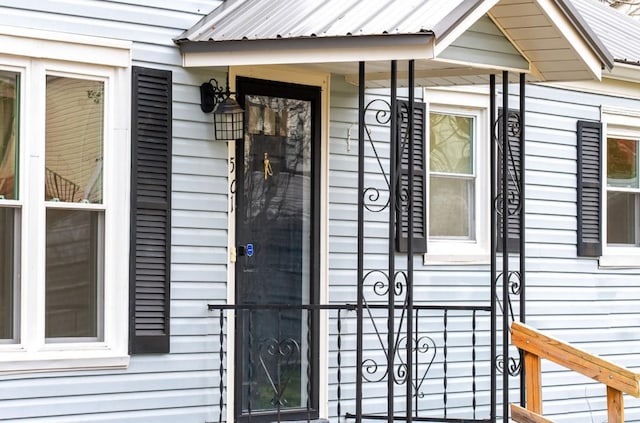 view of exterior entry featuring metal roof