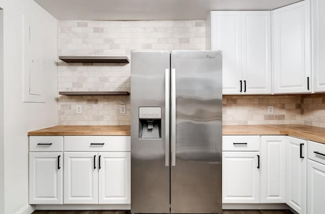 kitchen featuring open shelves, butcher block countertops, backsplash, and stainless steel fridge with ice dispenser