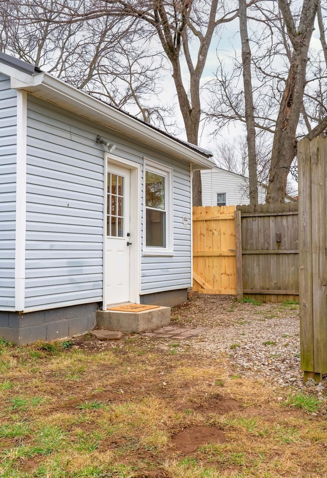 view of exterior entry featuring fence