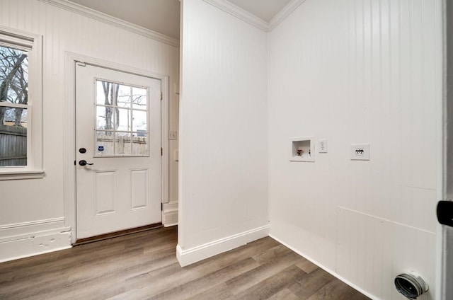 interior space with laundry area, ornamental molding, washer hookup, and wood finished floors