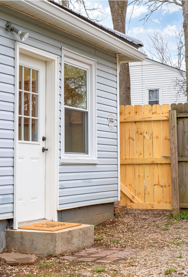 entrance to property featuring fence