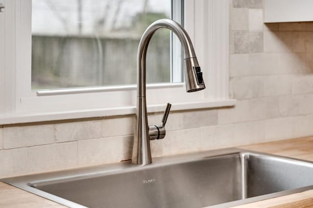 details with a sink and decorative backsplash