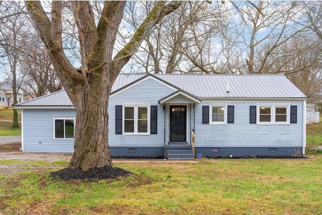 ranch-style home with a front yard, crawl space, metal roof, and entry steps