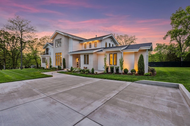 modern inspired farmhouse with a front yard, stucco siding, and fence