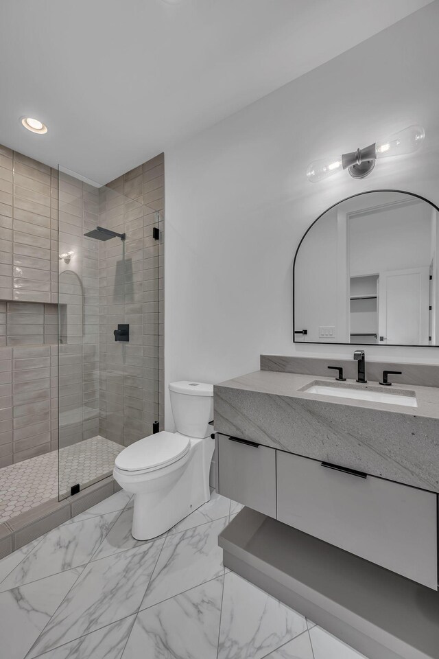 bathroom featuring recessed lighting, vanity, toilet, a stall shower, and marble finish floor