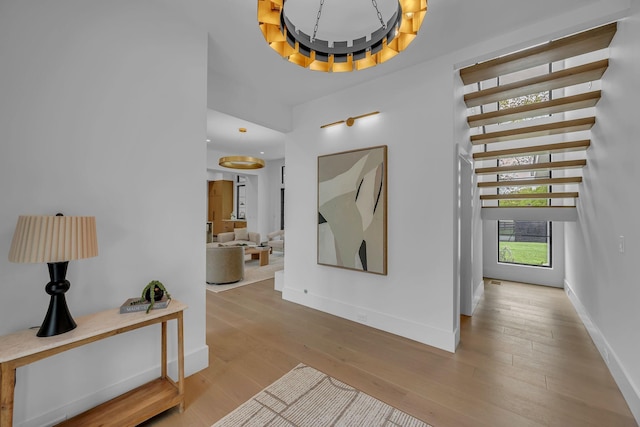 hall featuring wood finished floors and baseboards