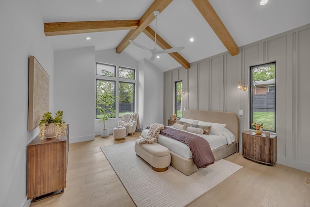 bedroom with recessed lighting, vaulted ceiling with beams, a decorative wall, and light wood-type flooring