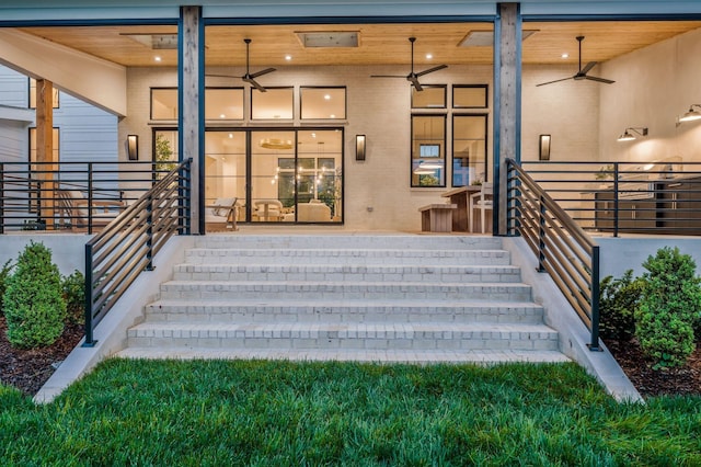 view of exterior entry featuring a ceiling fan