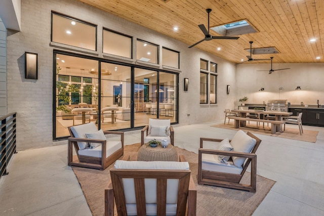 view of patio / terrace featuring area for grilling, grilling area, a ceiling fan, and an outdoor living space