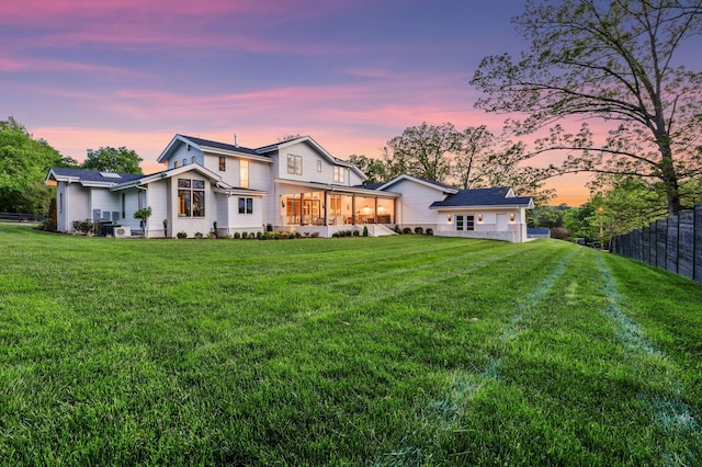 back of house with a yard and fence