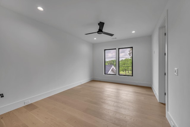 empty room featuring baseboards, light wood-type flooring, and ceiling fan