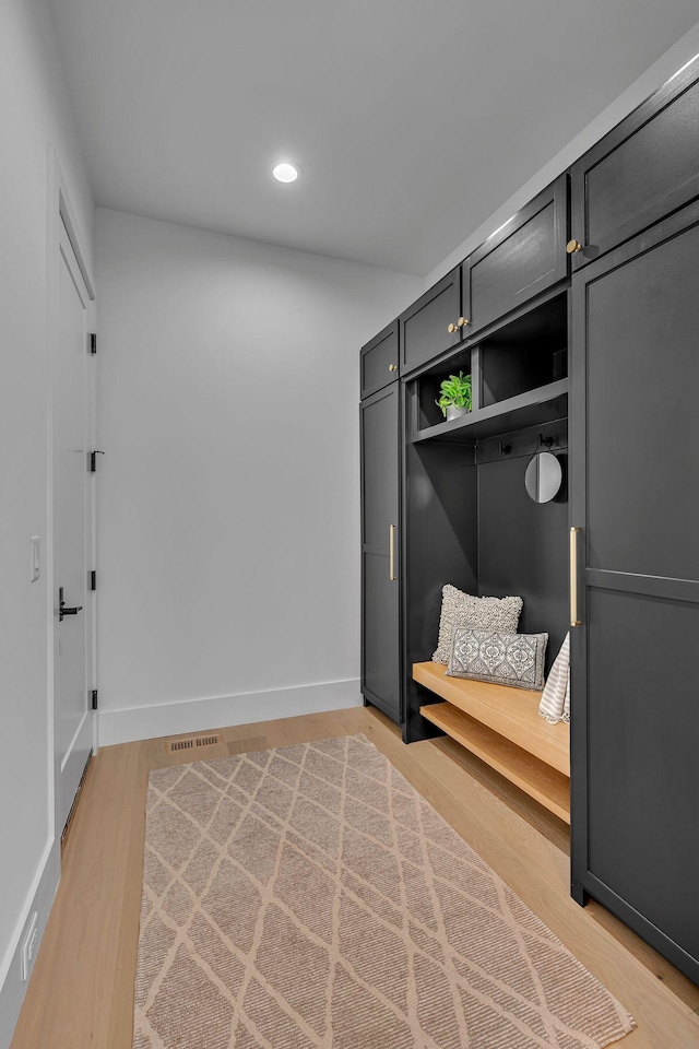 mudroom with baseboards, visible vents, light wood finished floors, and recessed lighting