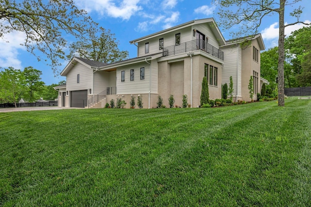 view of front of home with a front yard, driveway, an attached garage, and fence