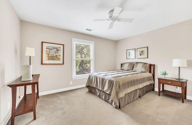 bedroom with light carpet, baseboards, visible vents, and a ceiling fan